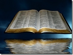 open_bible_over_black_and_blue_clouds_with_reflection